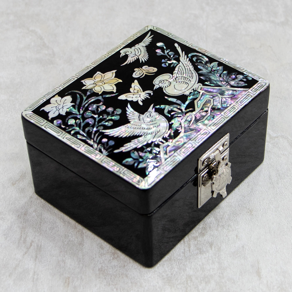 Mother-of-pearl jewelry box with interior compartments visible